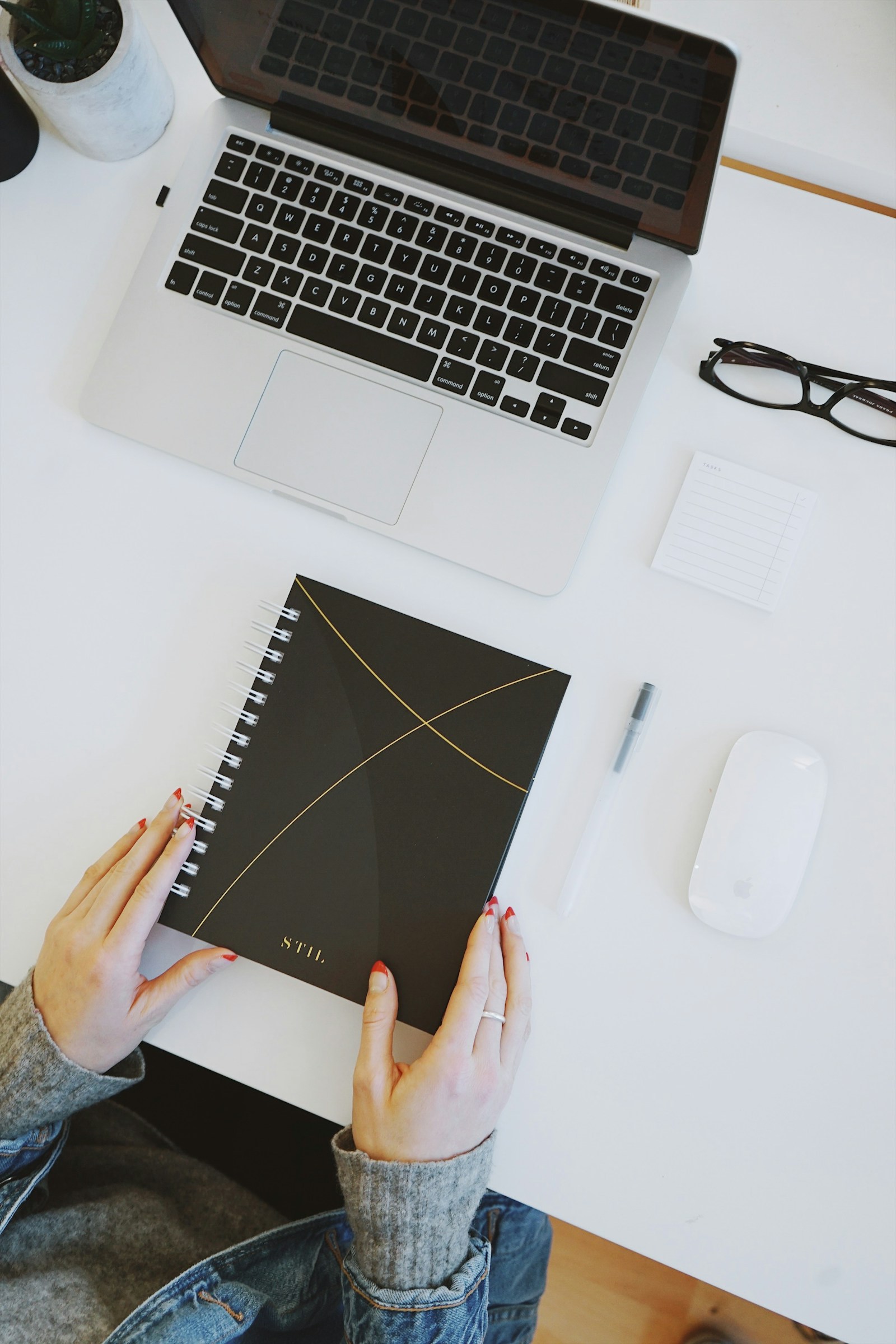 Organized workspace with a laptop, notebook, and planning materials